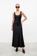 Woman wearing a black sleeveless dress on a white background